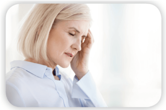 Blonde woman holding her head indicating she has a headache.