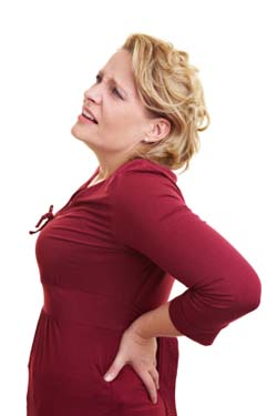 Woman holding her back in pain