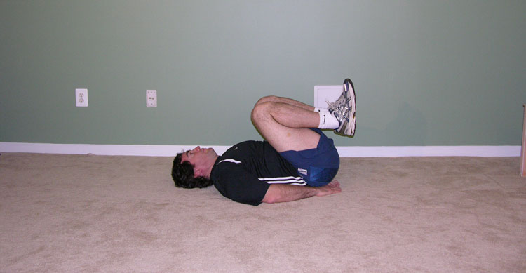 Man lying on back, stretching