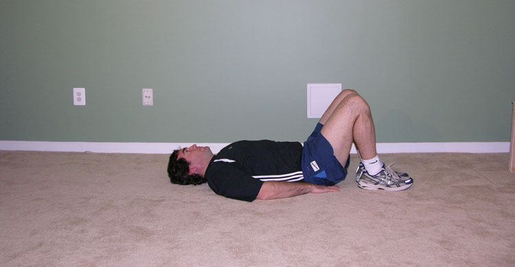 Man lying on back, stretching