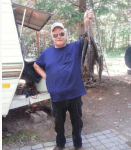 Man holding up string of fish.